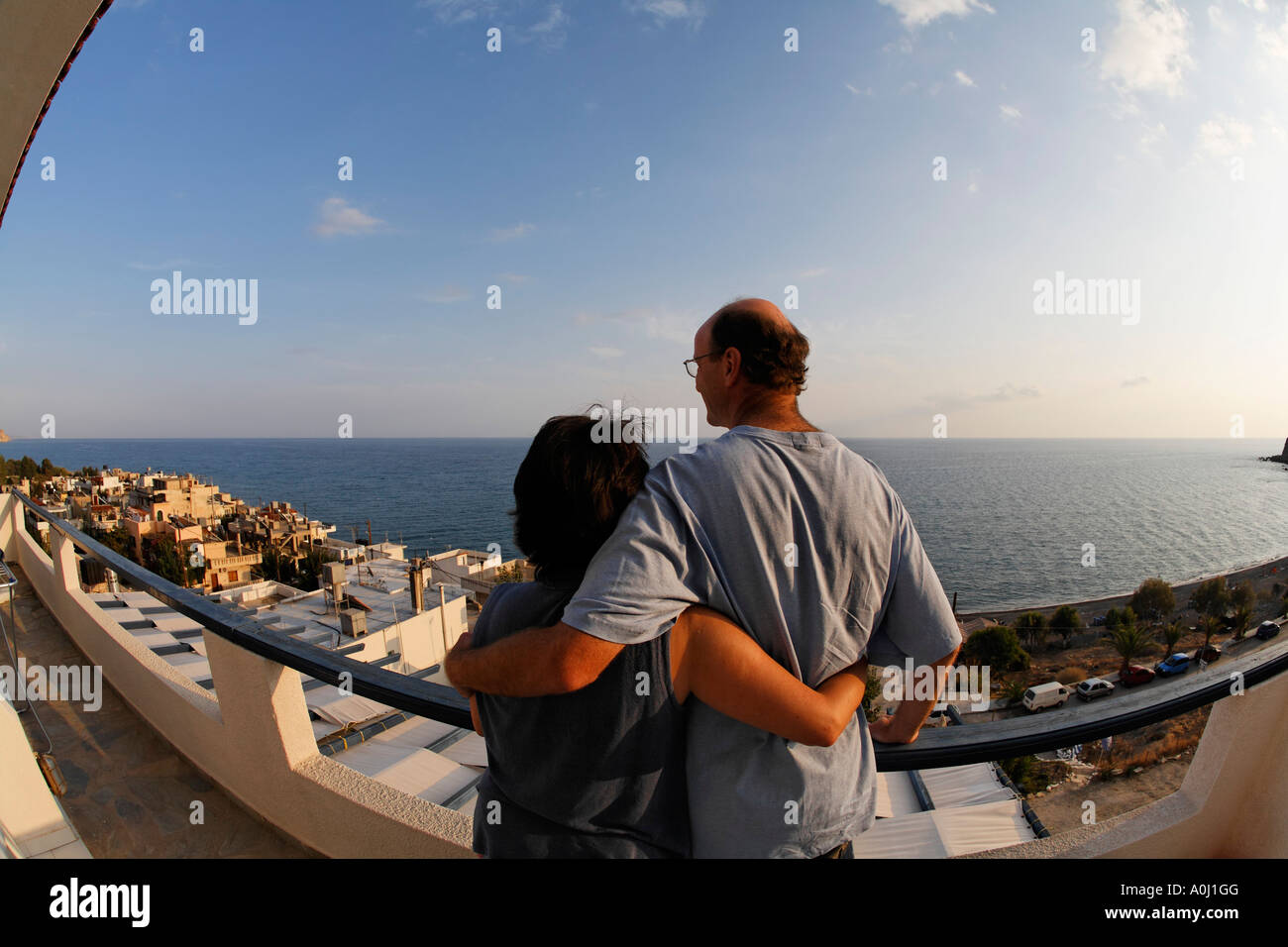 Couple at balcony of apartment Big Blue, Mirtos, Southern Crete, Greece Stock Photo