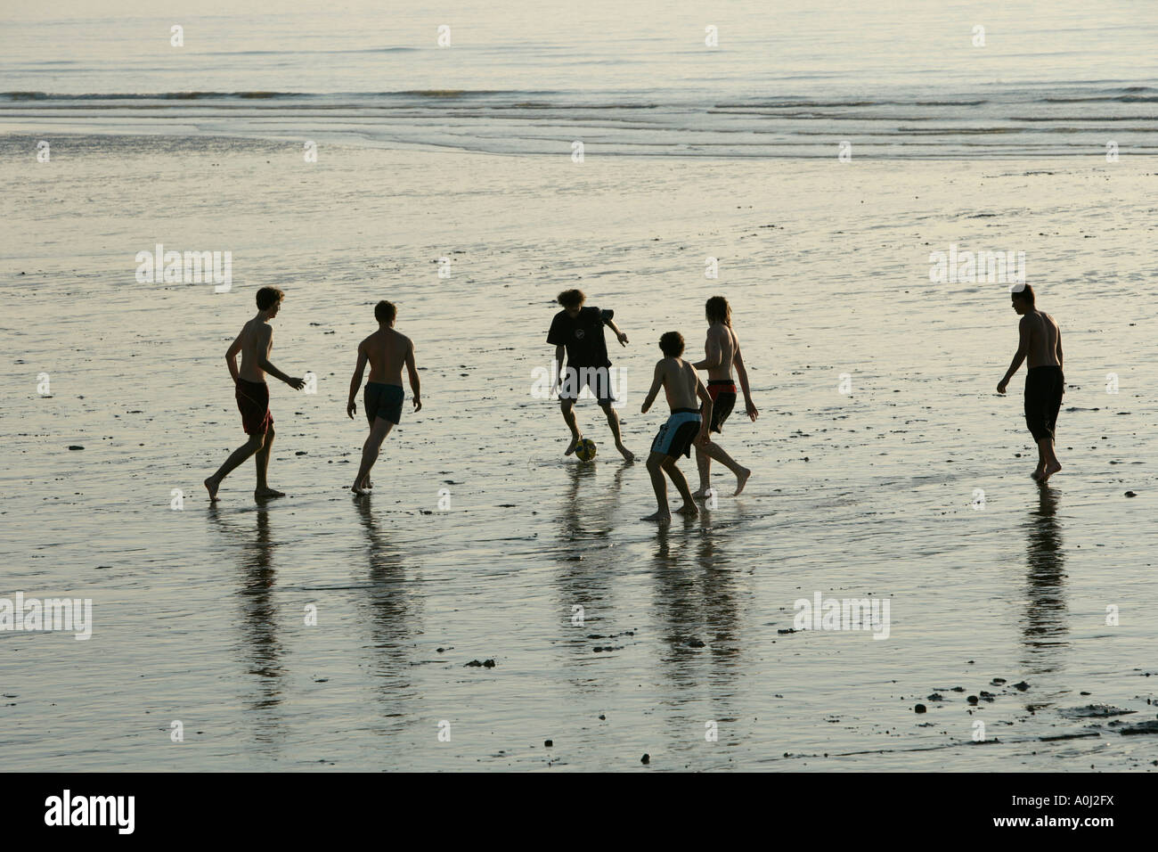 Young men playing soccer on the beach , Normandy , France , Europa Stock Photo