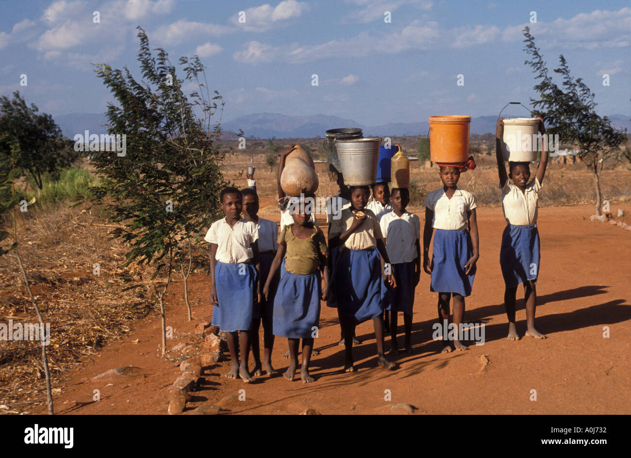 School children with water barrels Dodoma Tanzania Stock Photo