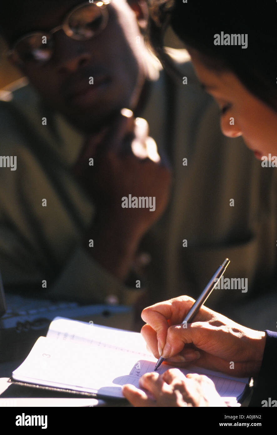 Woman scheduling man for appointment Stock Photo