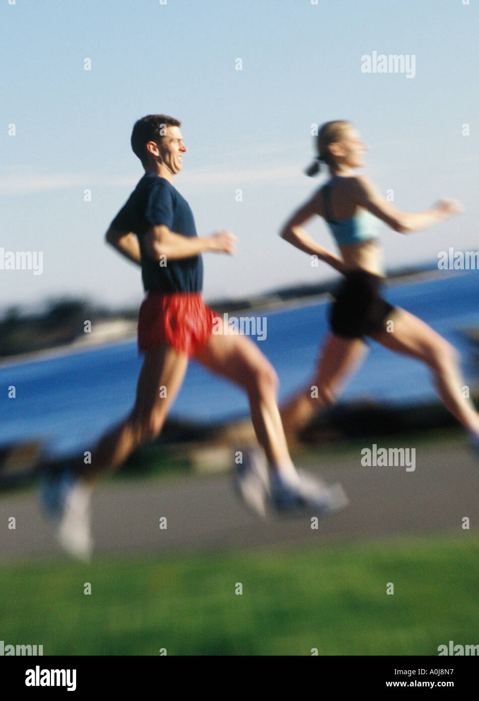 Young man and woman jogging Stock Photo