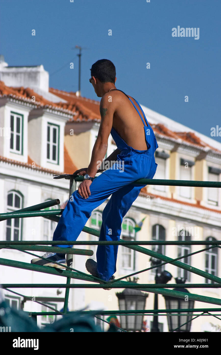 worker sitting on scaffold Stock Photo