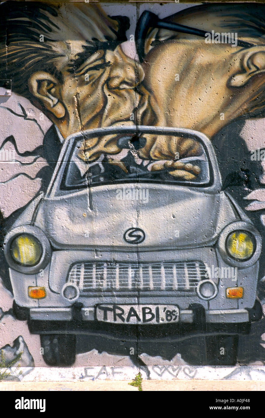 Berlin. Germany. Caricature of Leonid Brezhnev & Erich Honecker kissing in a Trabant, by Christian Wahle aka Lake, 1990, The East Side Gallery. Stock Photo