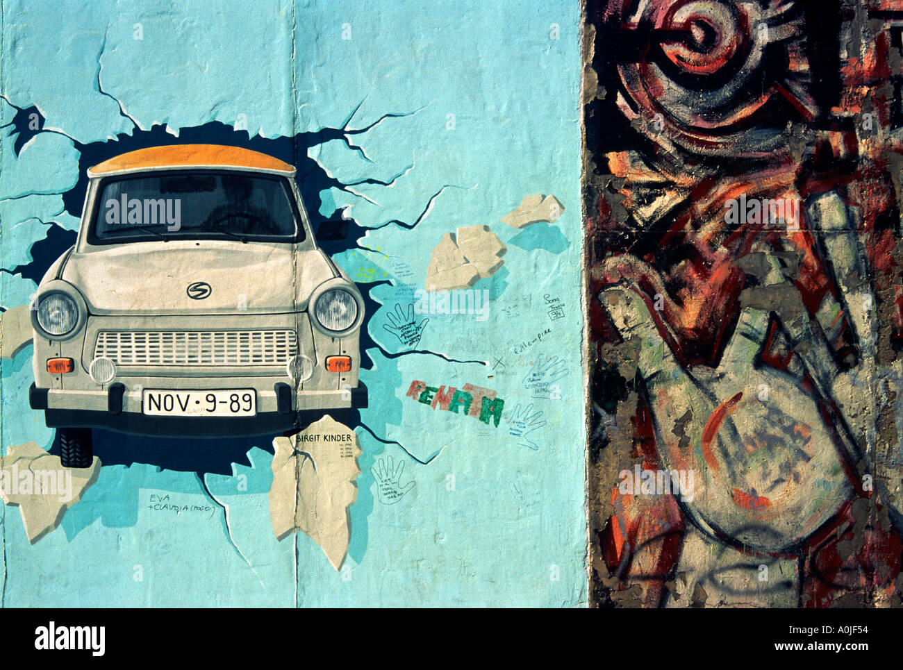 Berlin. Germany. The East Side Gallery, Test the Best, painting of a Trabant breaking through the Berlin Wall, by Birgit Kinder, 1990, and Hands by Ma Stock Photo