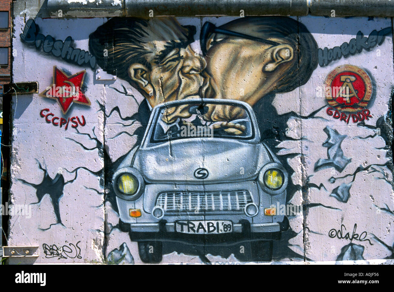 Berlin. Germany. Caricature of Leonid Brezhnev & Erich Honecker kissing in a Trabant, by Christian Wahle aka Lake, 1990, The East Side Gallery. Stock Photo