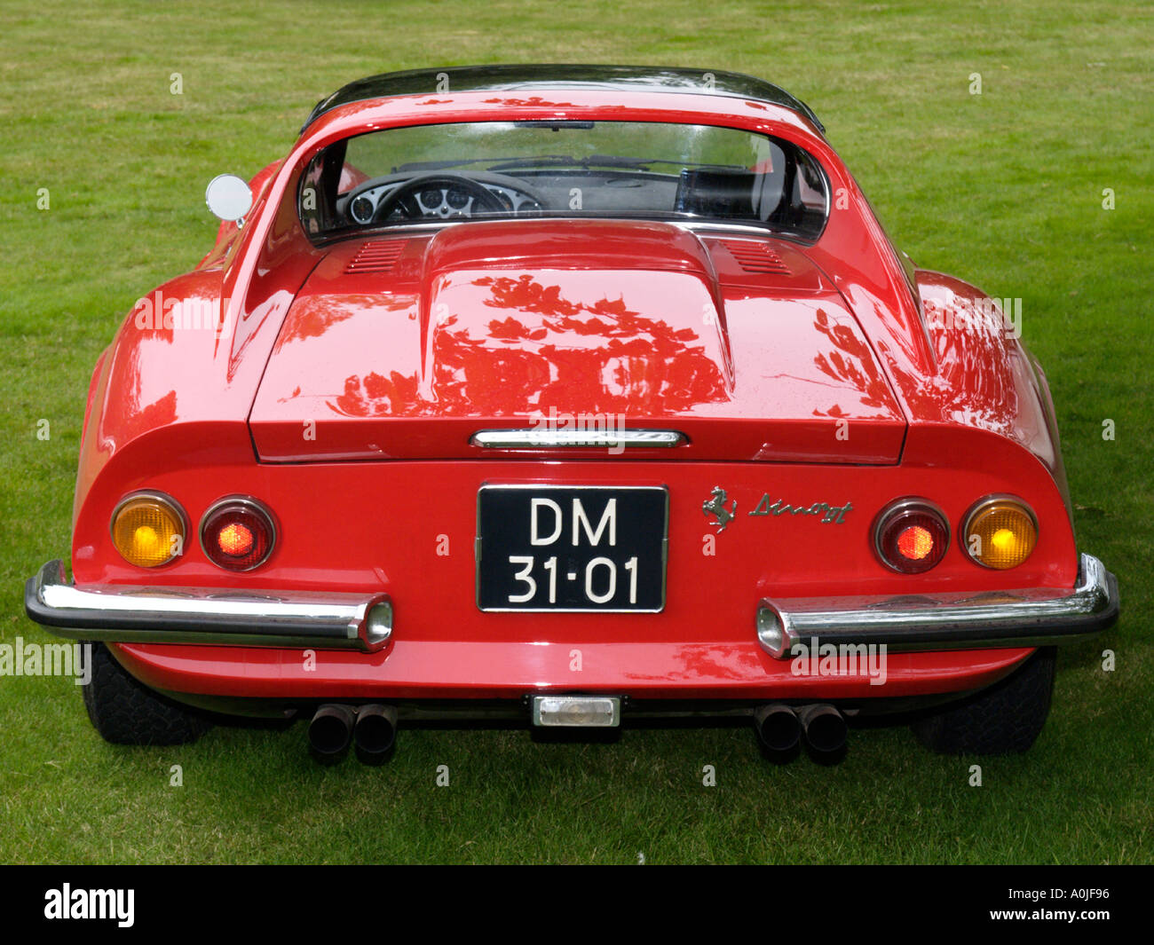 Rear side of a classic red Ferrari Dino 246 GT parked on the grass Stock Photo