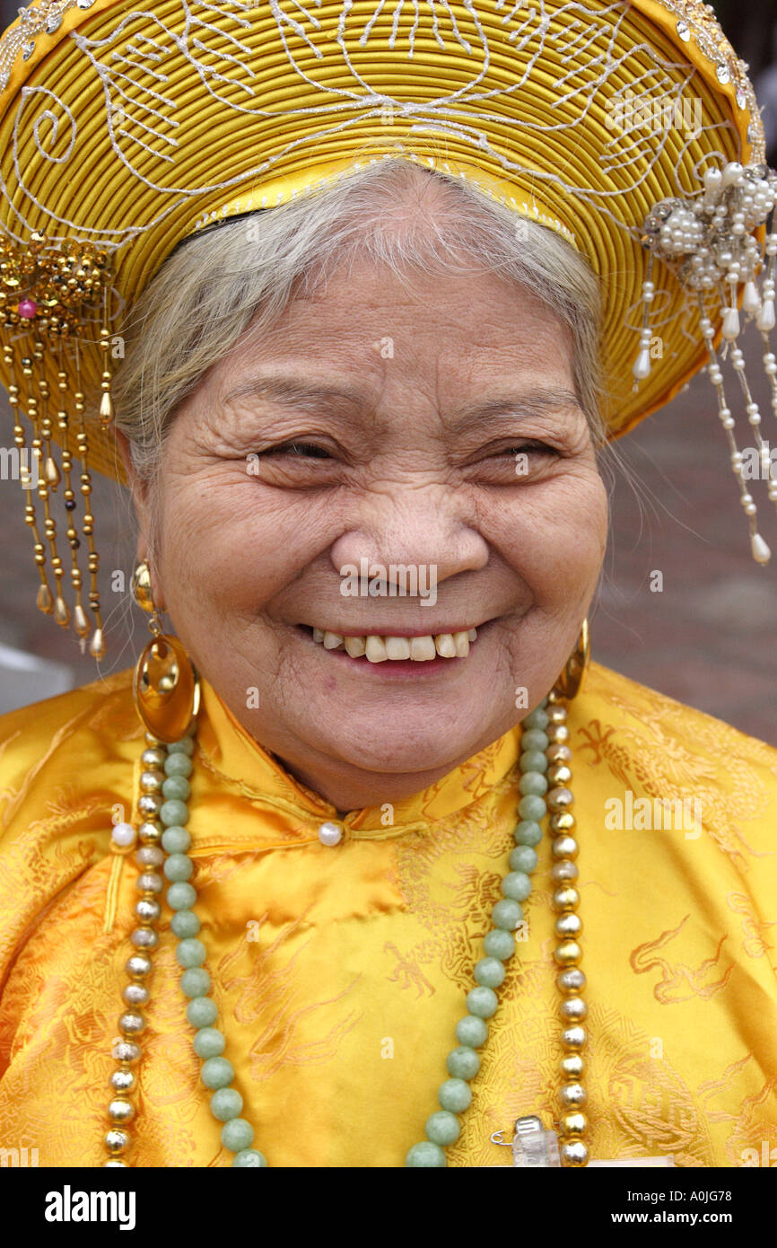 An older woman wearing a traditional costume in a park in Hanoi Vietnam Stock Photo