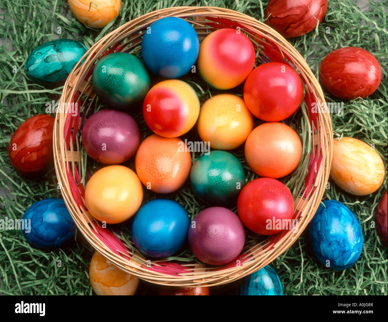 children playing outdoor in garden with painted Easter eggs in a basket Stock Photo