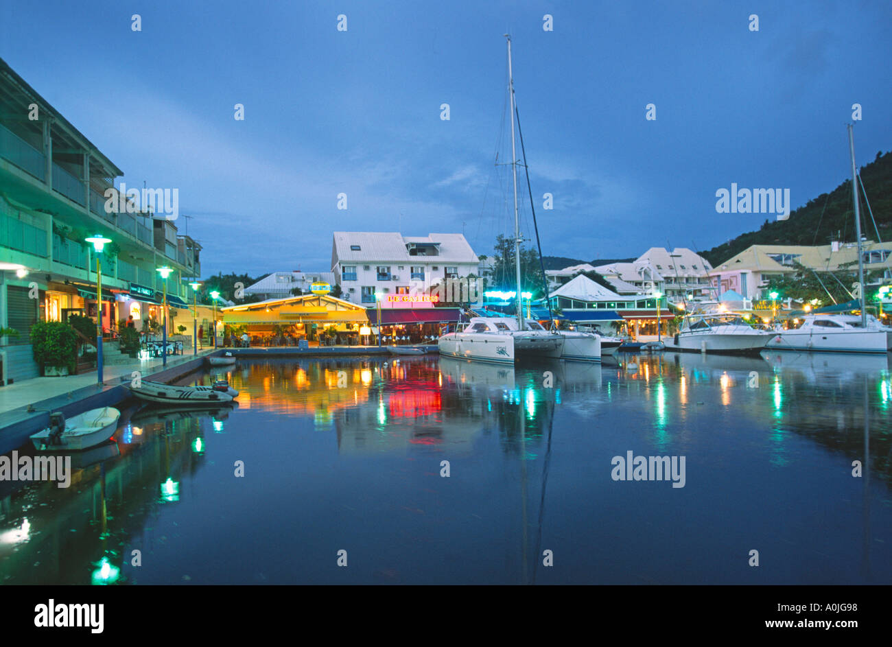 Marigot Saint Martin French West Indies Sailing boats dusk pier with restaurants Stock Photo