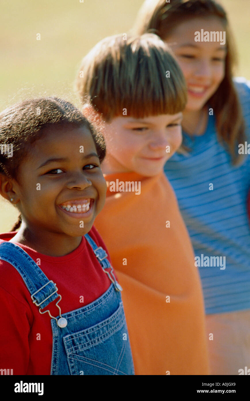 Two girls and a boy standing together Stock Photo - Alamy
