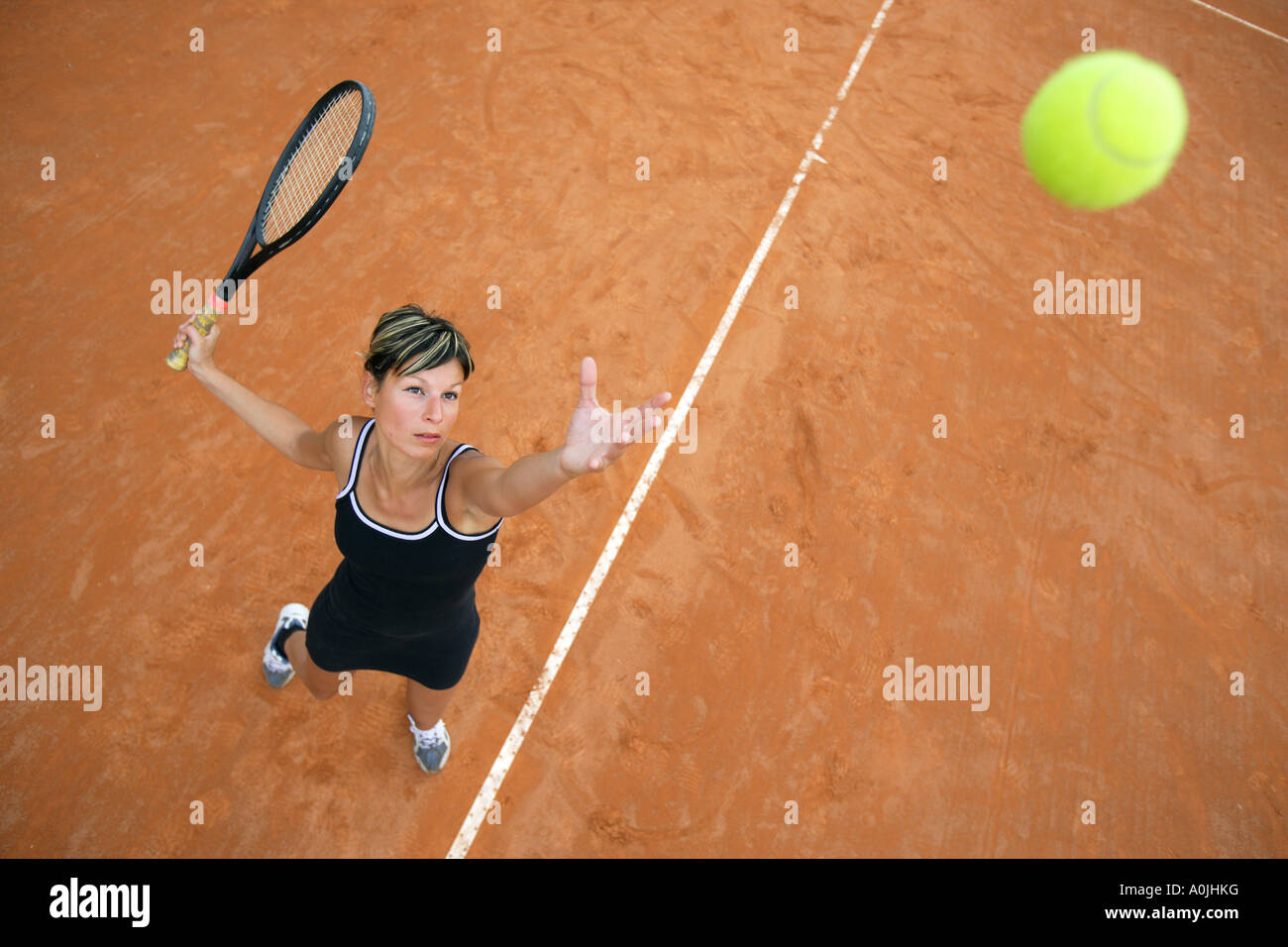 Bird s Eye View of Female Tennis Player Serving Stock Photo