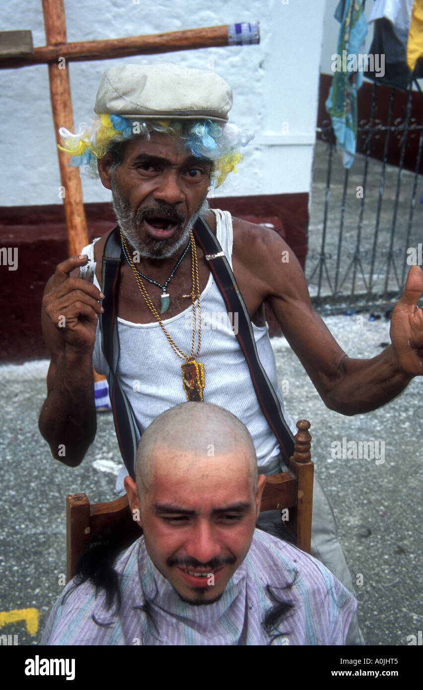 Barber cutting hair at Portobelo during the Black Christ Festival Stock Photo