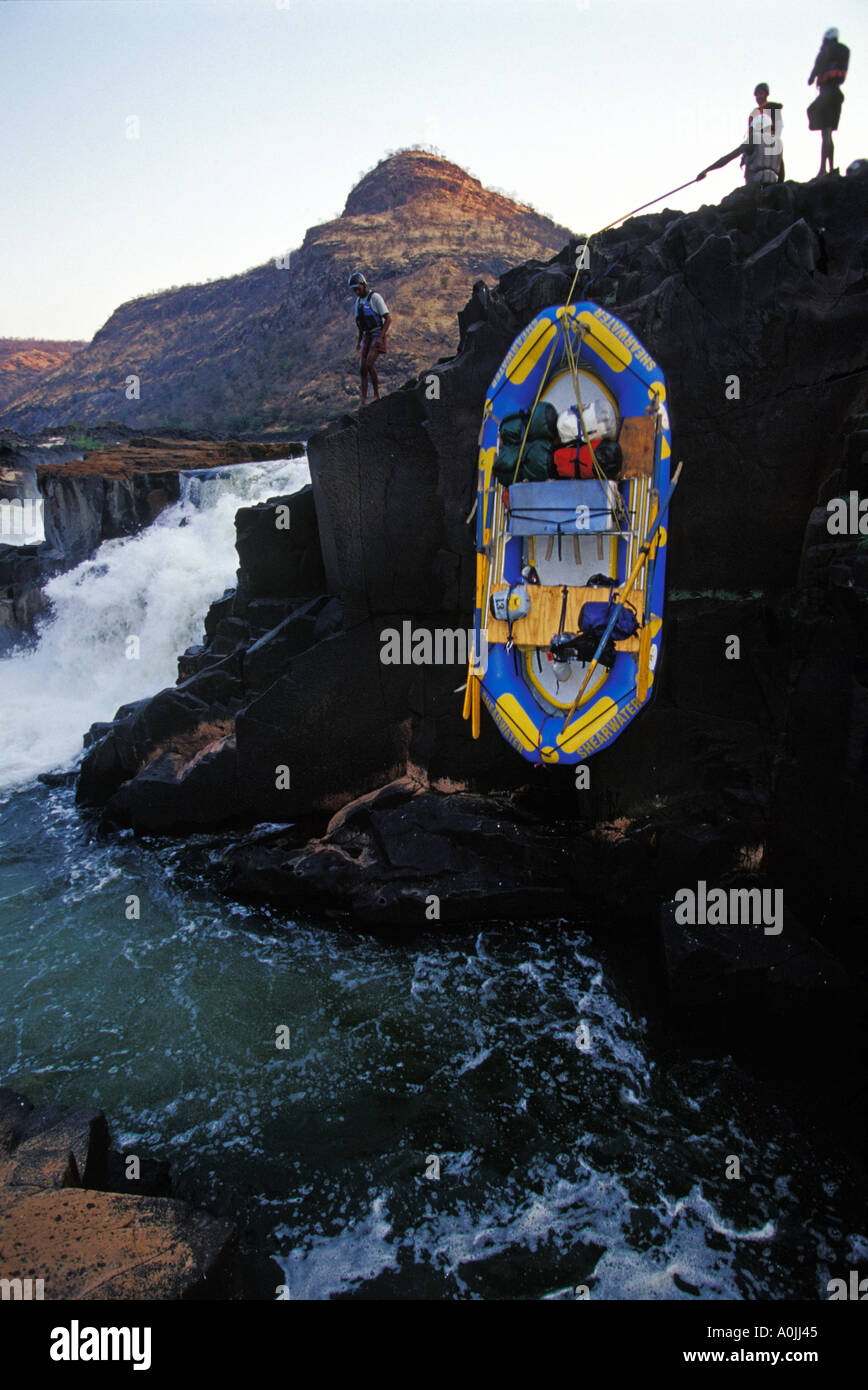 Whitewater Rafting Guides Portaging Rafts and Equipment Below Mowenba Falls on the Zambezi river