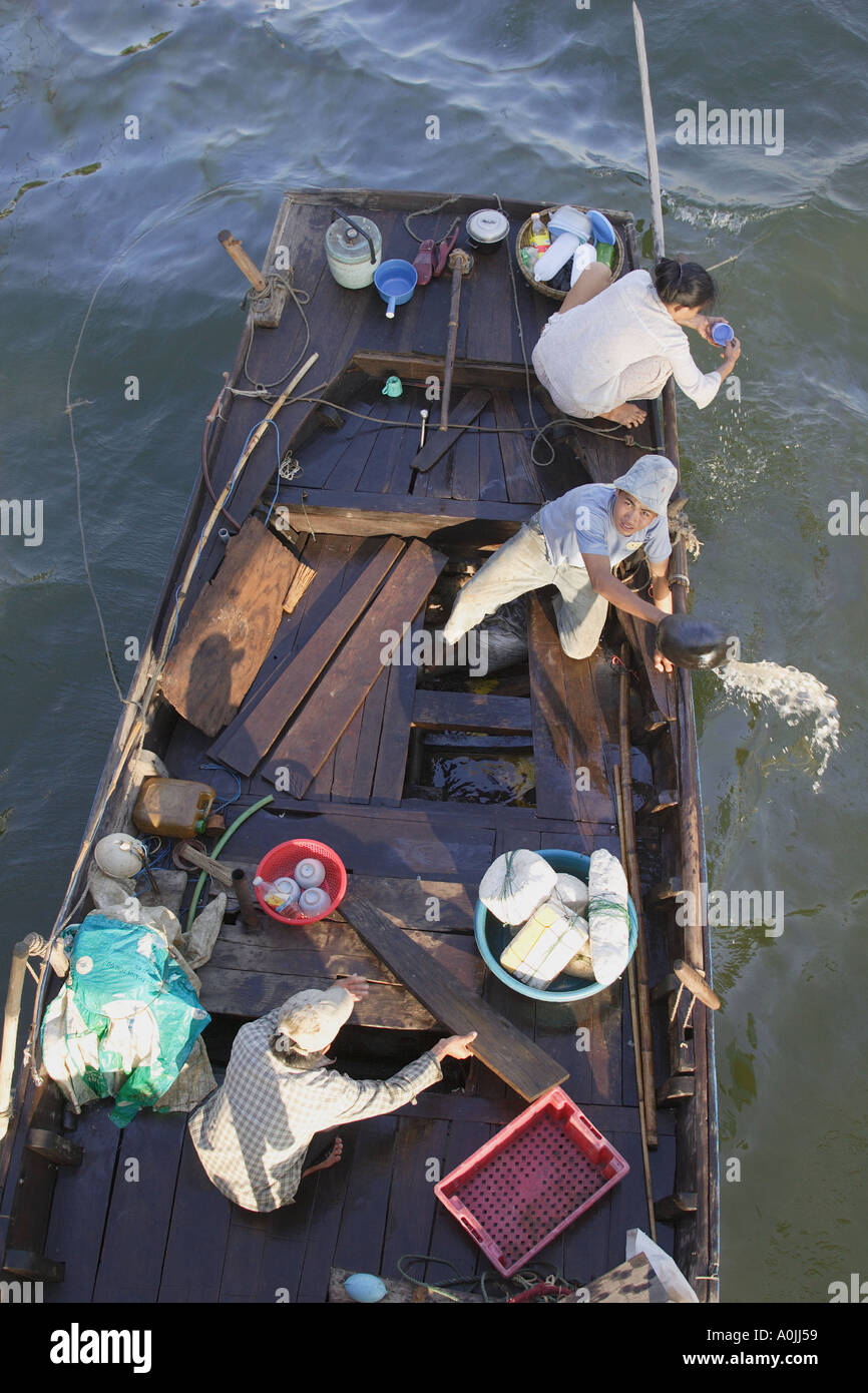 Fishermen bailing out their boat in Vietnam Stock Photo