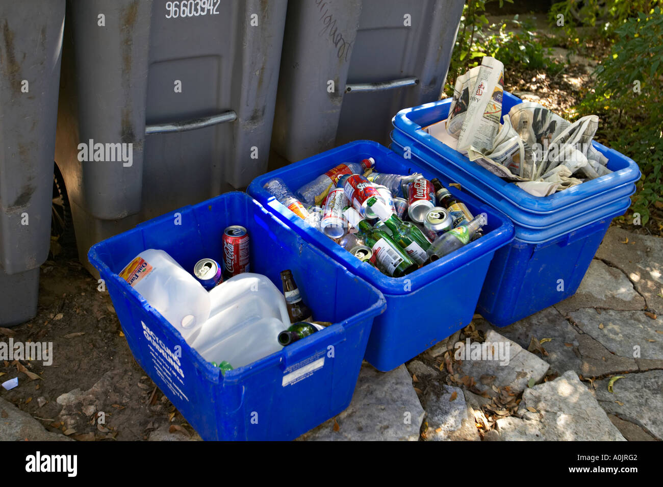 TEXAS Austin Blue bins of recycling materials on sidewalk outside home on Bremond Block district