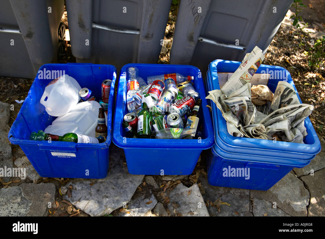 TEXAS Austin Blue bins of recycling materials outside home on Bremond Block district with