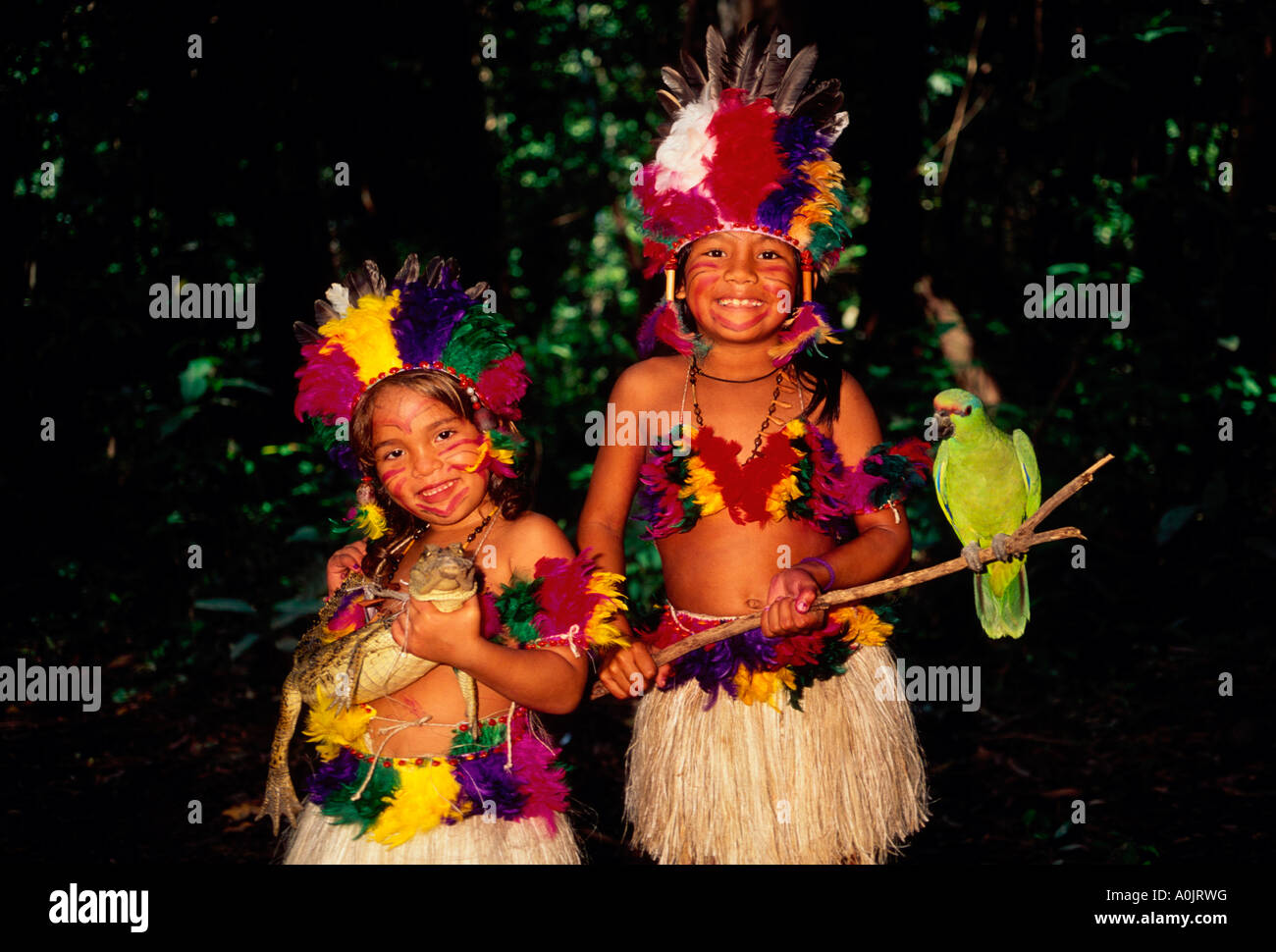 2, two, Brazilian girls, green parrot, caiman, on Terra Nova Island along the Amazon River east Manaus in Amazonas State, Brazil, South America Stock Photo