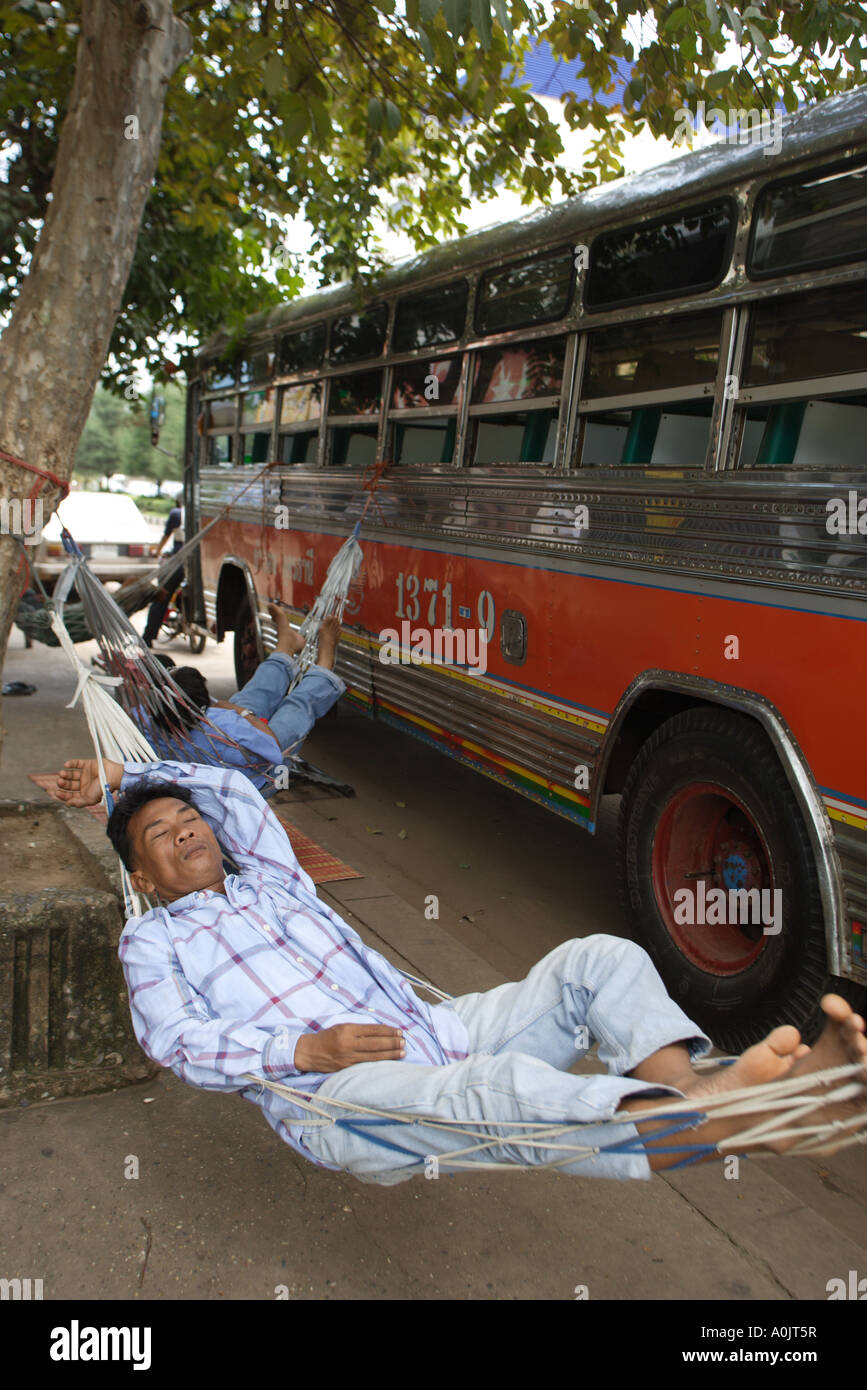 A sleeping bus driver in a hammock in Udon Thani North East Thailand