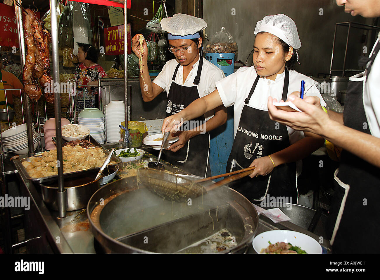 A speciality noodle maker prepares a dish in Chinatown Bangkok Thailand