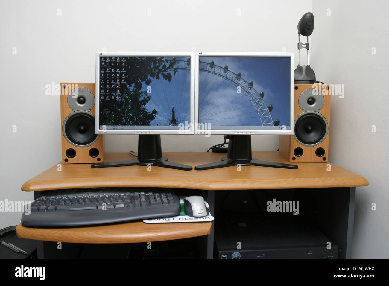 Modern Pc On Desk With Speakers And Dual Flatscreen Monitors Stock