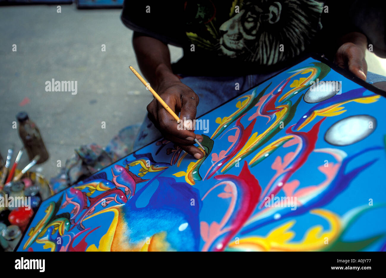 Zanzibari artist paints Tingatinga painting Stone town Zanzibar Tanzania Stock Photo