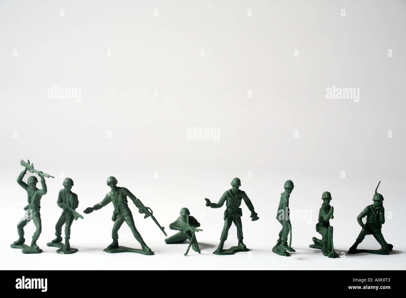close up colour image off eight green toy soldiers standing upright in