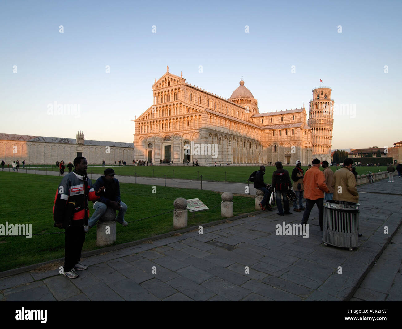 African immigrants selling fake designer goods watches at Italy s number one tourist location the leaning tower of Pisa Stock Photo