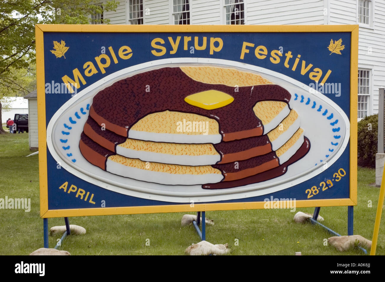 Maple Syrup Festival Sign depicts syrup over pancake with butter on