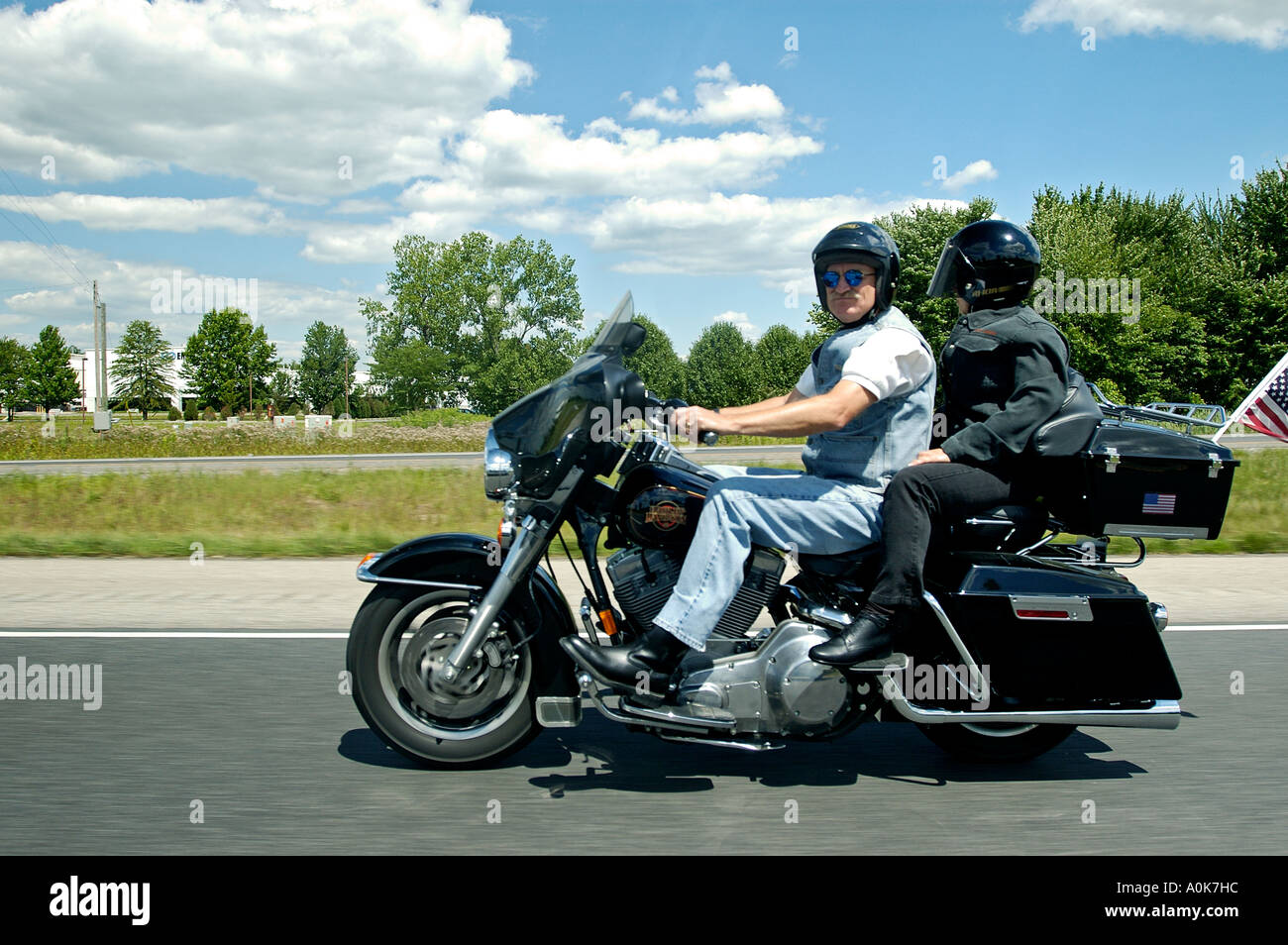 Senior Couple Riding Harley Davidson Motorcycle On Interstate Highway in Indiana Stock Photo