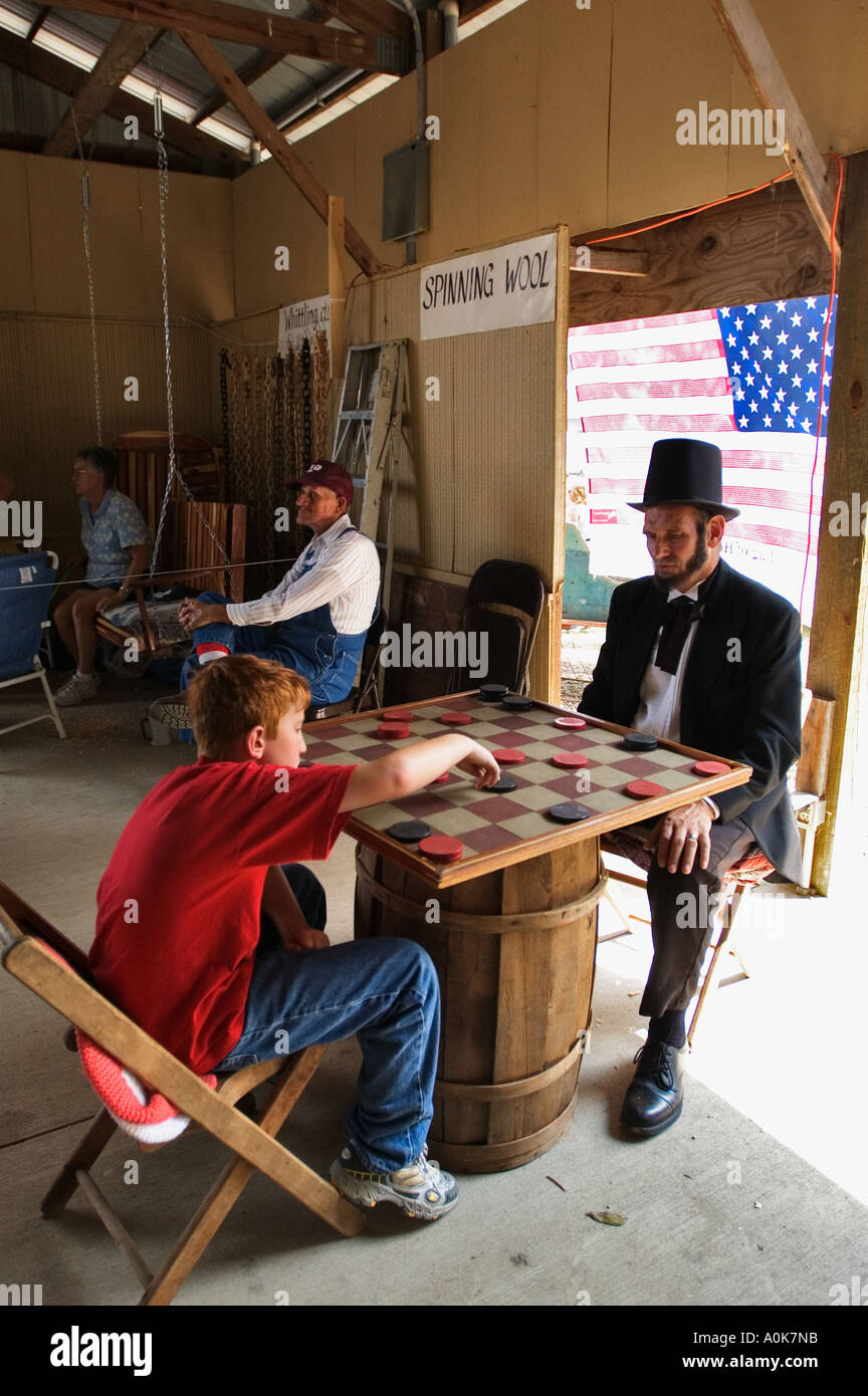 Young Boy Playing Checkers With Abe Lincoln Impersonator Lanesville Heritage Festival Lanesville Indiana Stock Photo