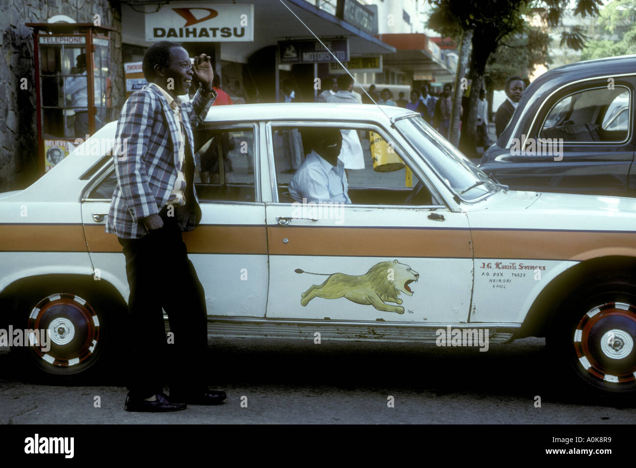 Nairobi taxi and driver chatting to a friend whilst waiting for business Nairobi Kenya East Africa Stock Photo