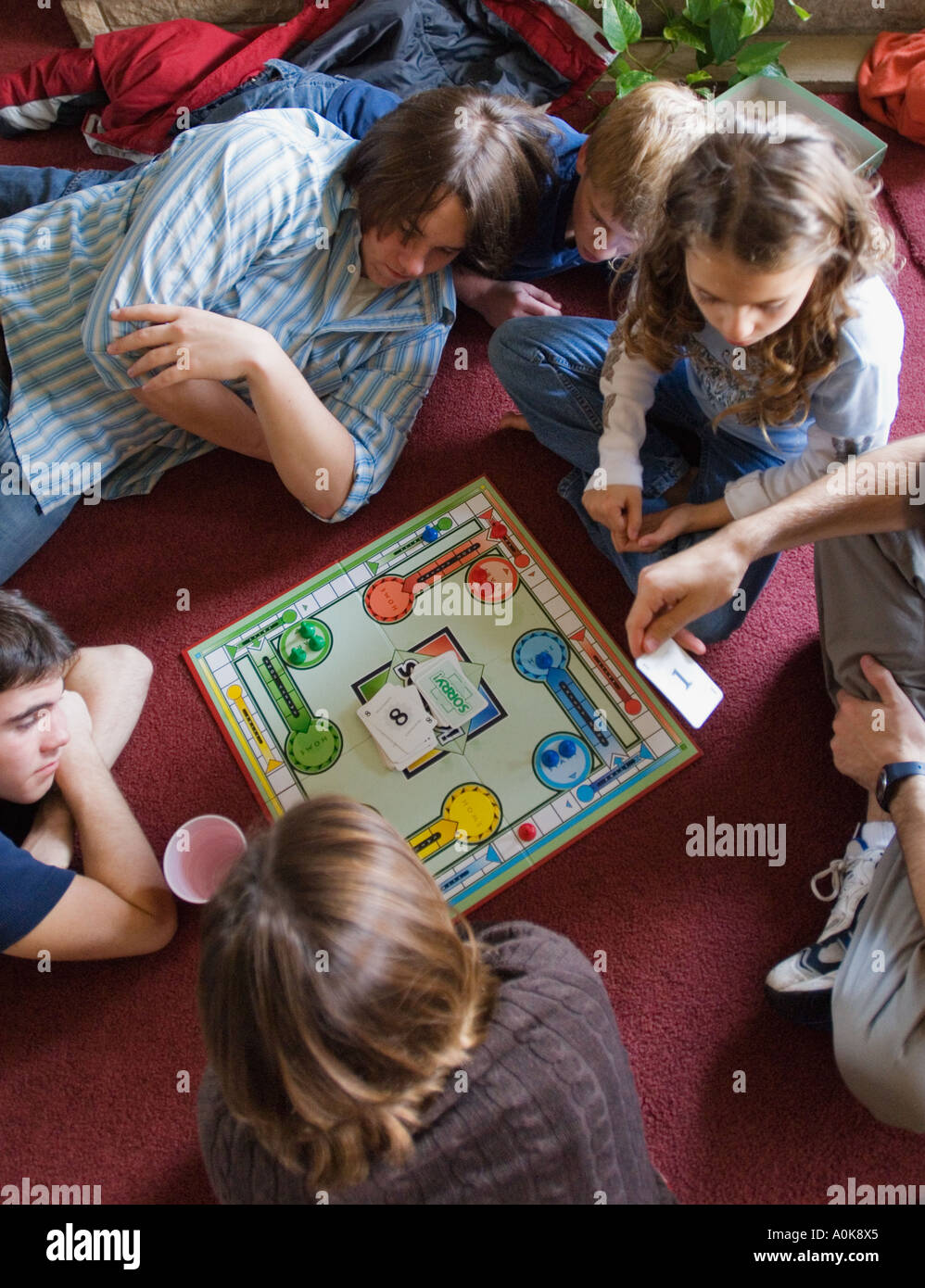Cousins of Various Ages Playing Board Game At Family Reunion in Floyd County Indiana Stock Photo