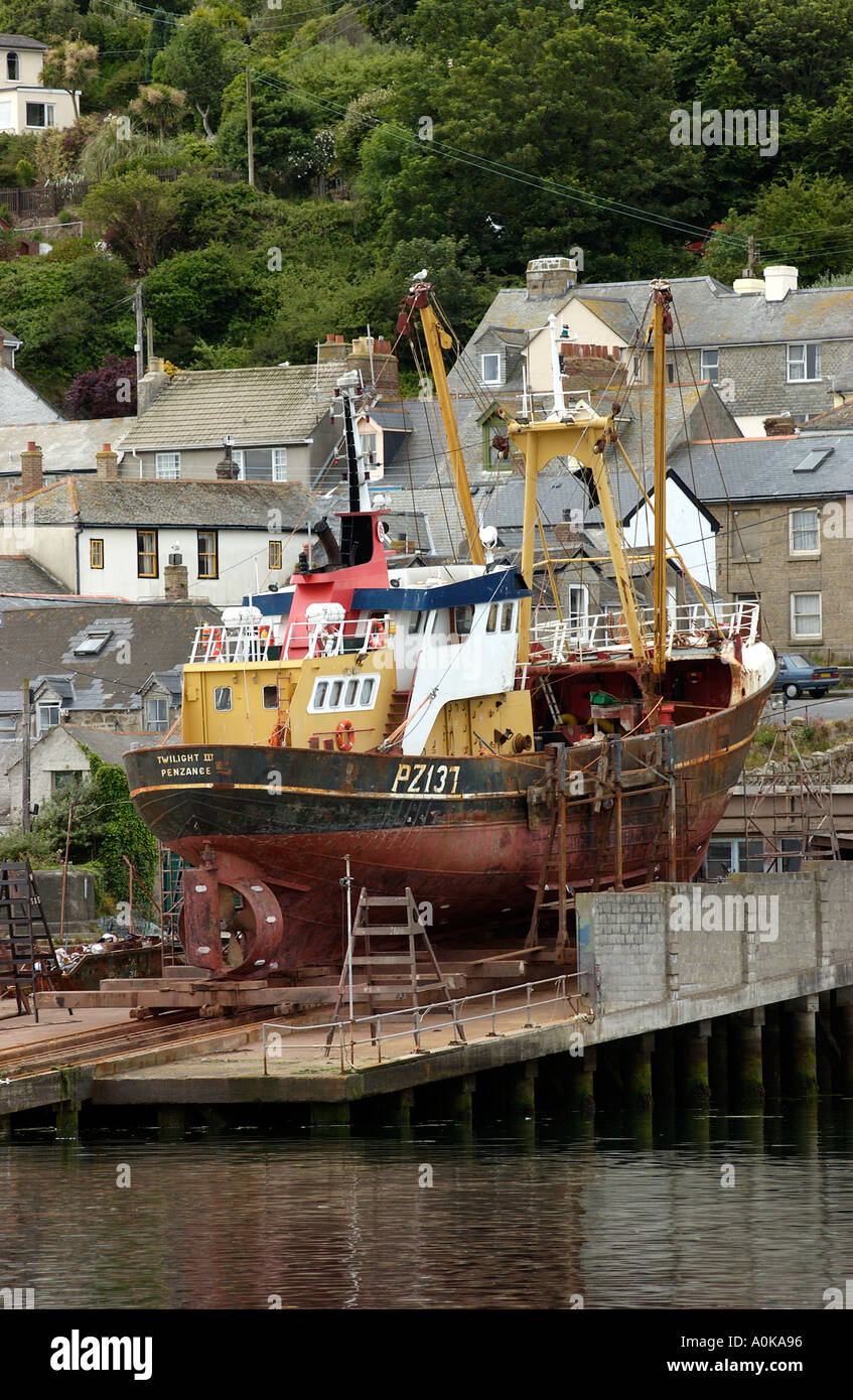 A beam trawler laid up on a slipway for repair at Newlyn in Cornwall England UK 2004 Stock Photo