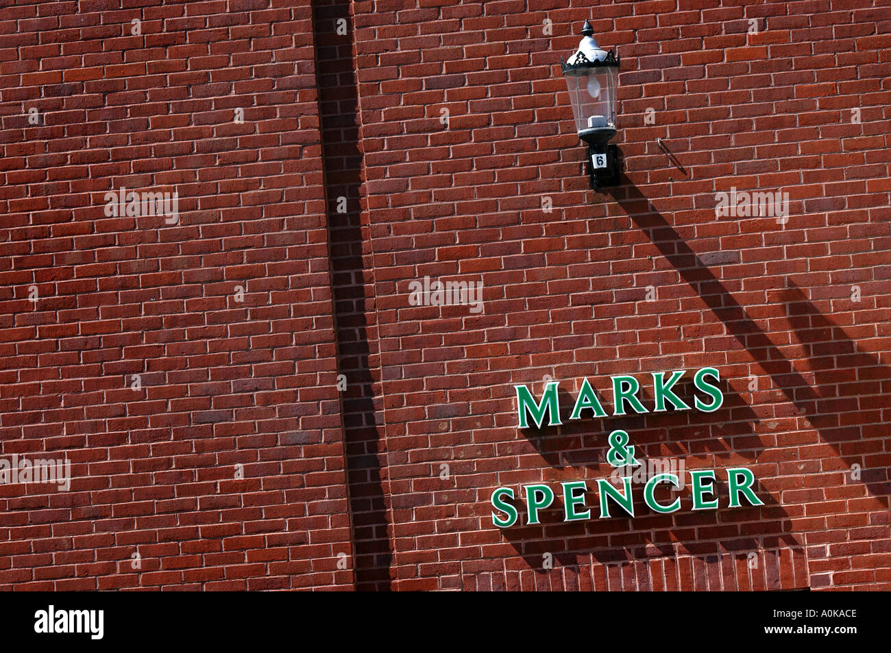A marks and spencer sign on the side of a brick wall in barnstaple devon Stock Photo