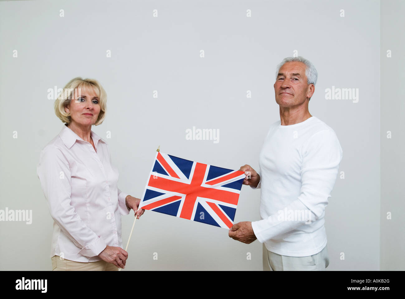 mature woman and mature man showing Union Jack Stock Photo