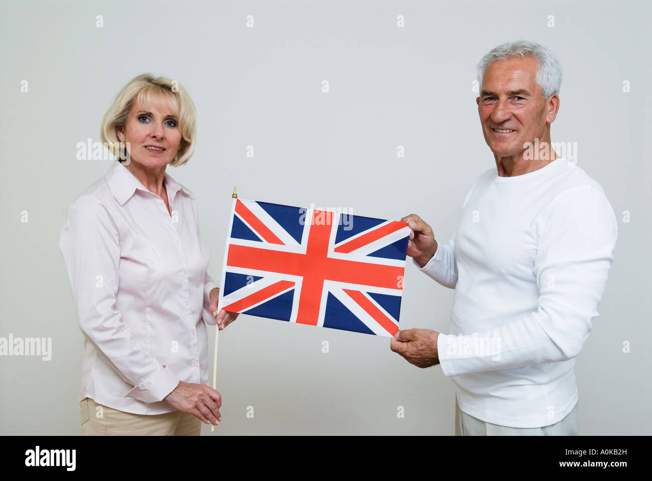 mature people holding British flag Stock Photo