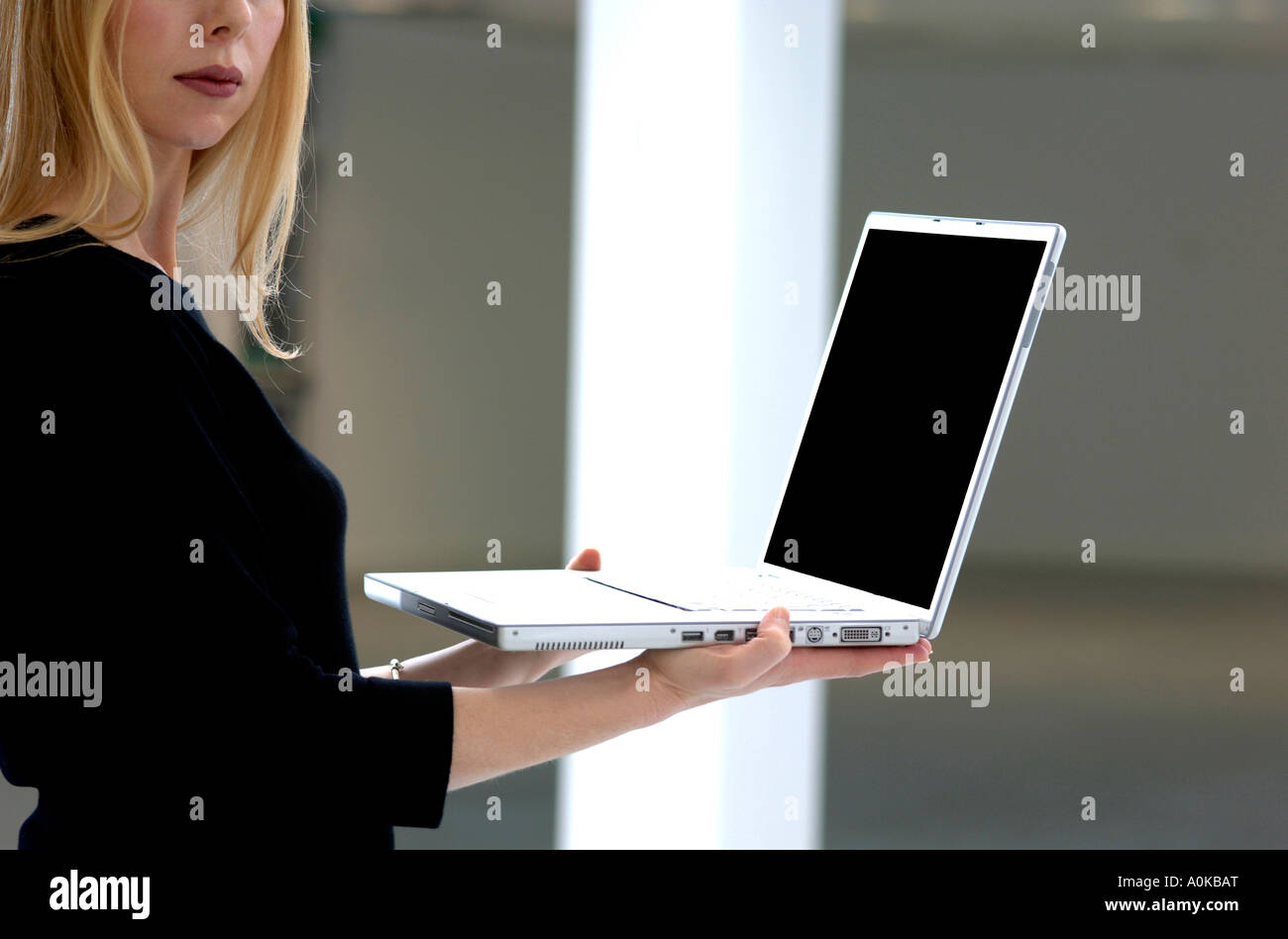 young woman holding laptop computer Stock Photo - Alamy