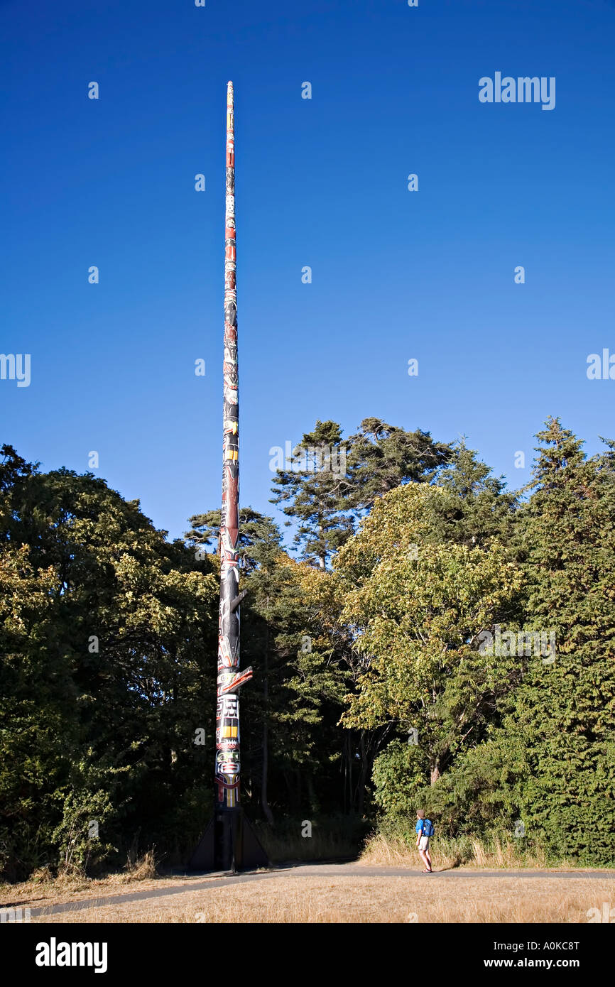 Woman looking at totem pole erected in memory of British Columbian Indians who died in the World Wars Victoria Canada Stock Photo
