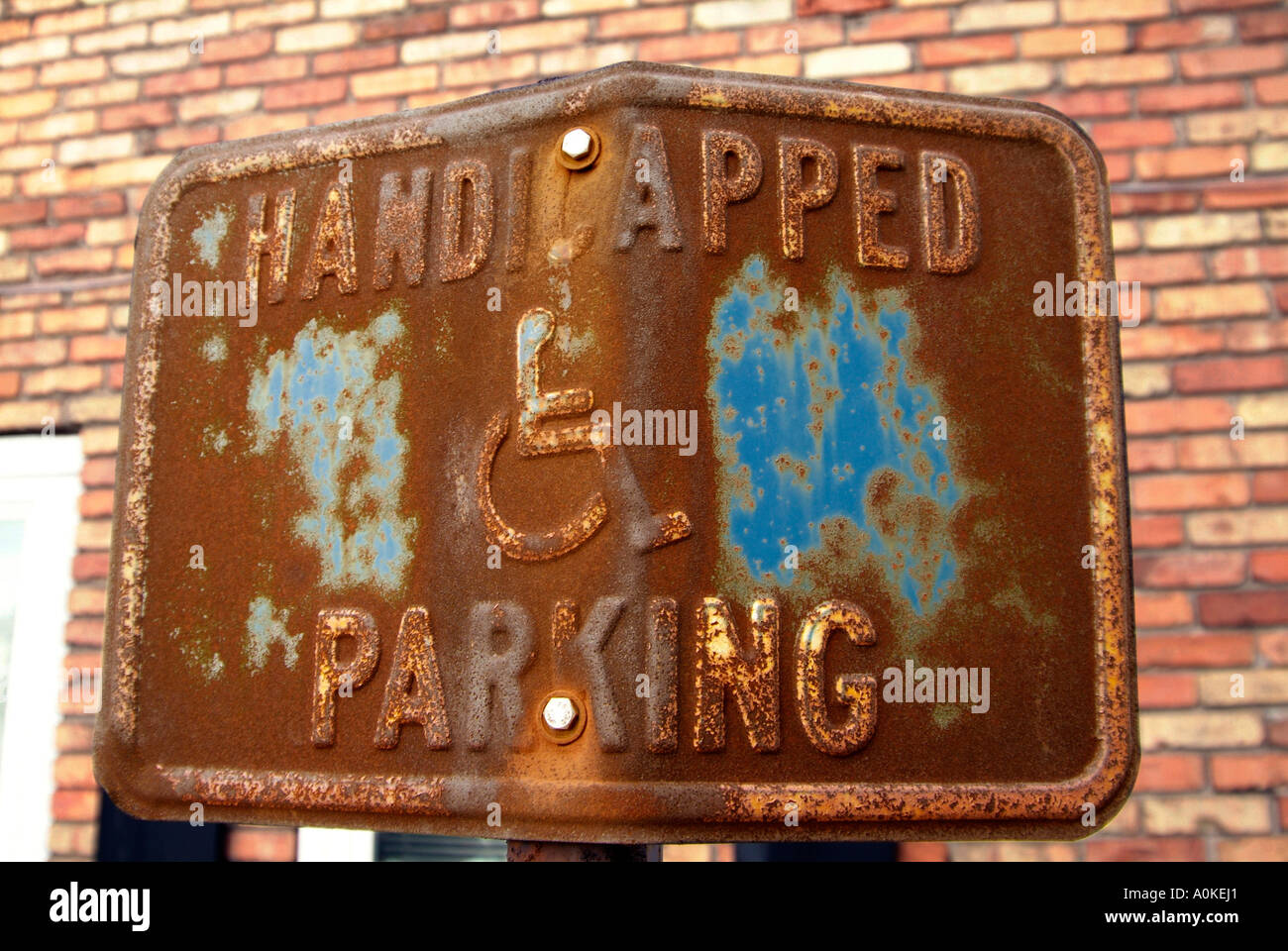 Old weathered rusty handicapped parking sign Stock Photo
