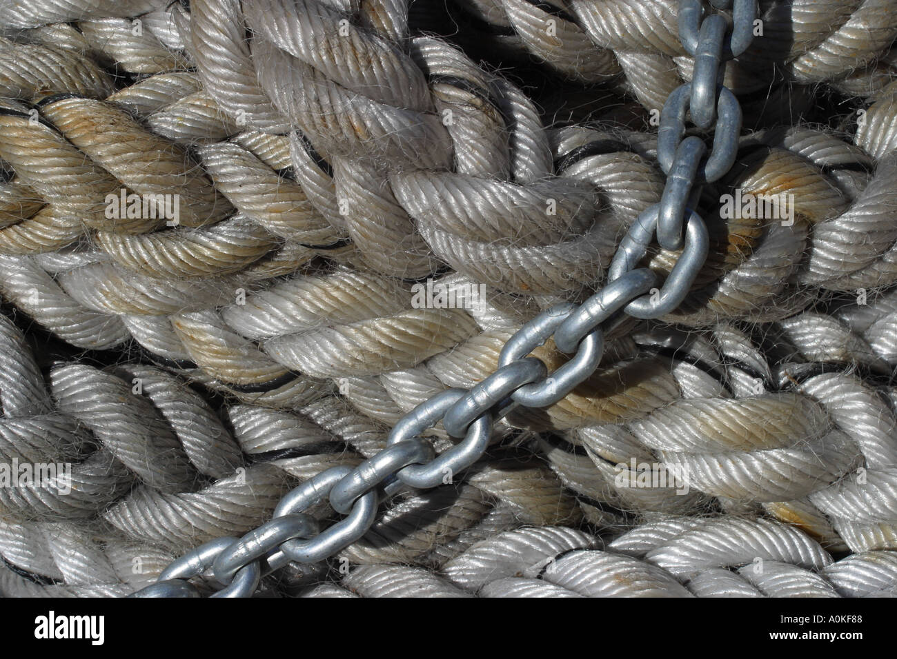 Coiled rope with a metal chain Stock Photo