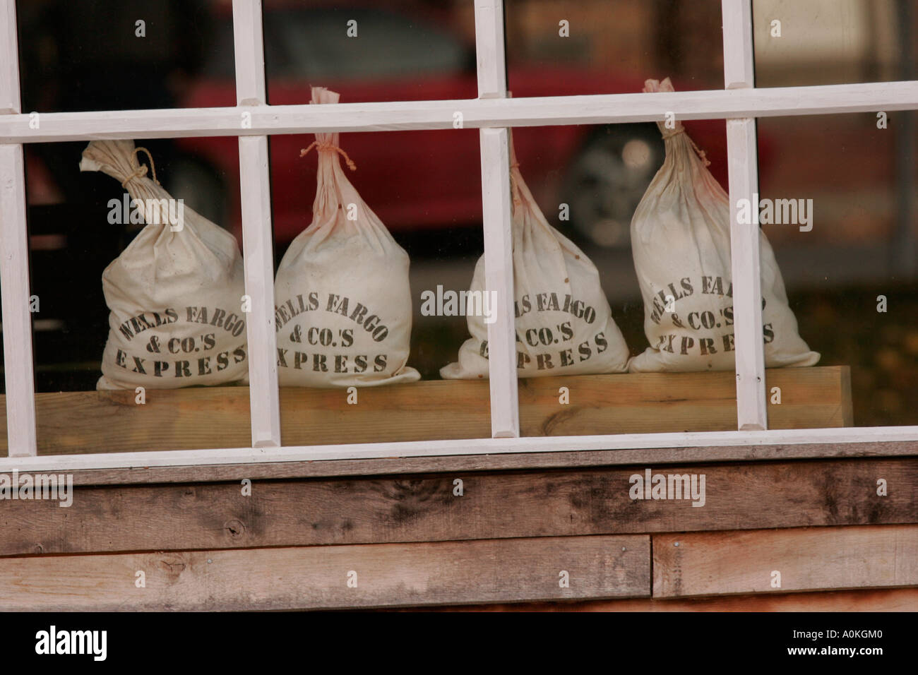 Old money bags in the window of old western town building on the Mississippi River Stock Photo