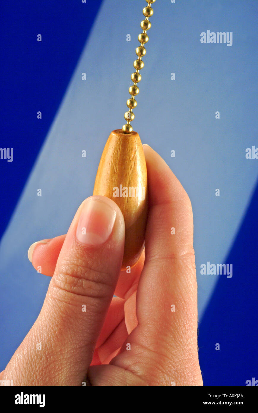 Fingers pulling chain on lamp Stock Photo Alamy