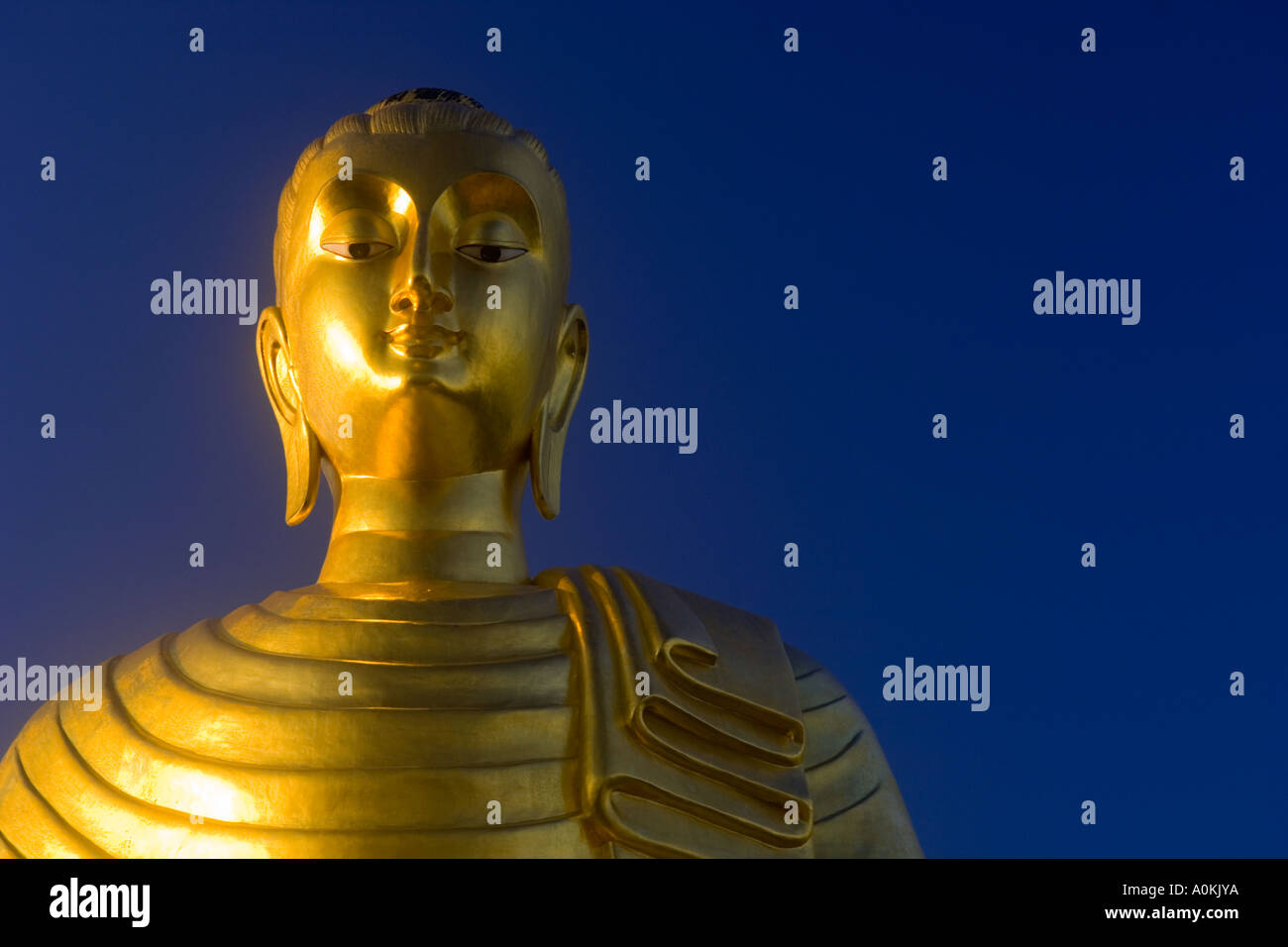 The Buddha against a blue sky background Stock Photo - Alamy