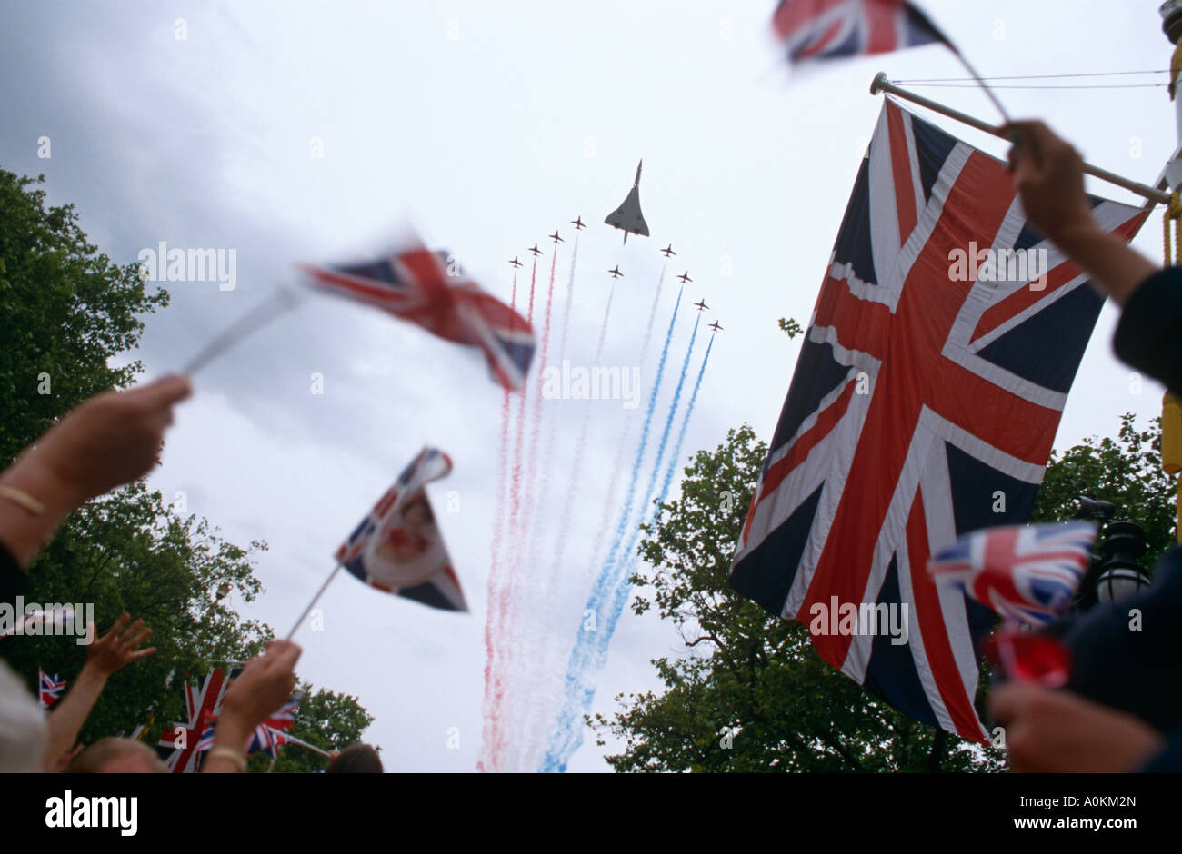 A fly past by Concorde and the RAF Red Arrows down The Mall at the Queens Golden Jubilee celebration in June 2002 London UK Stock Photo