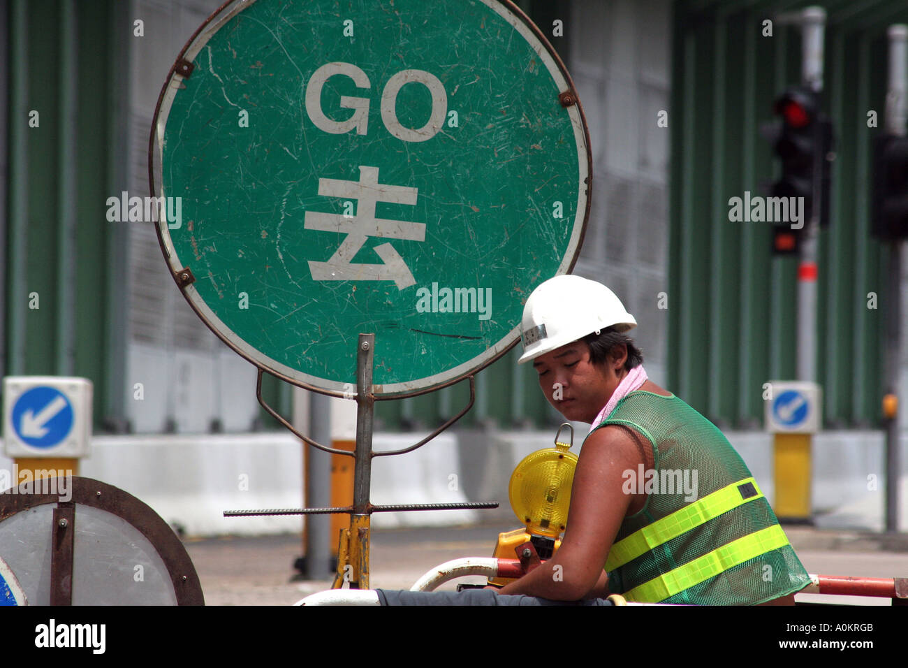 Construction worker controls traffic flow, Hong Kong Stock Photo