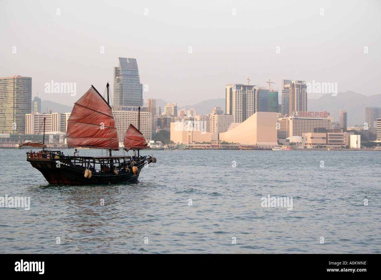 Old junk in front of TST, Kowloon in Victoria Harbor Hong  Kong Stock Photo