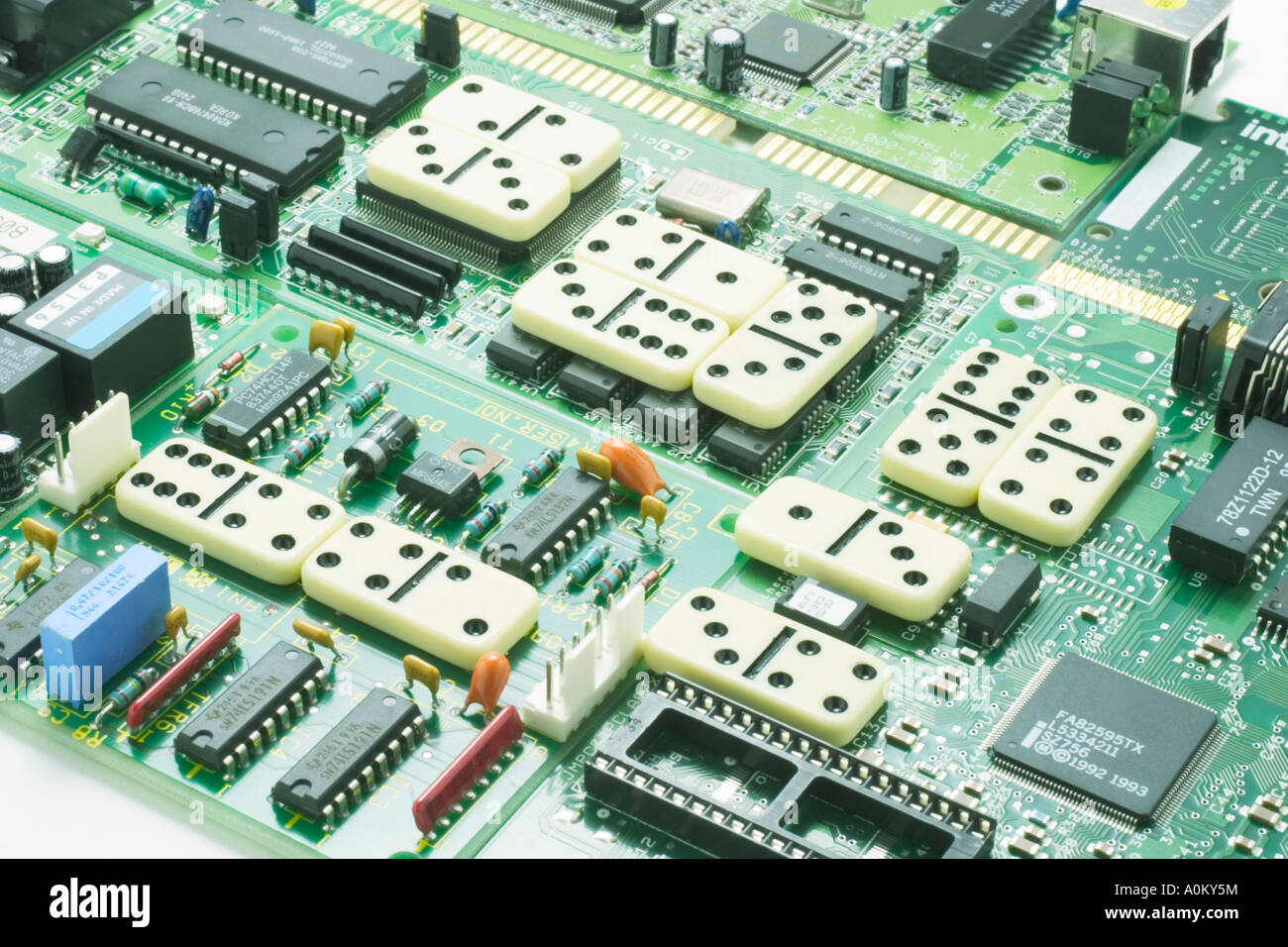 Dominoes on Computer Circuit Board Stock Photo