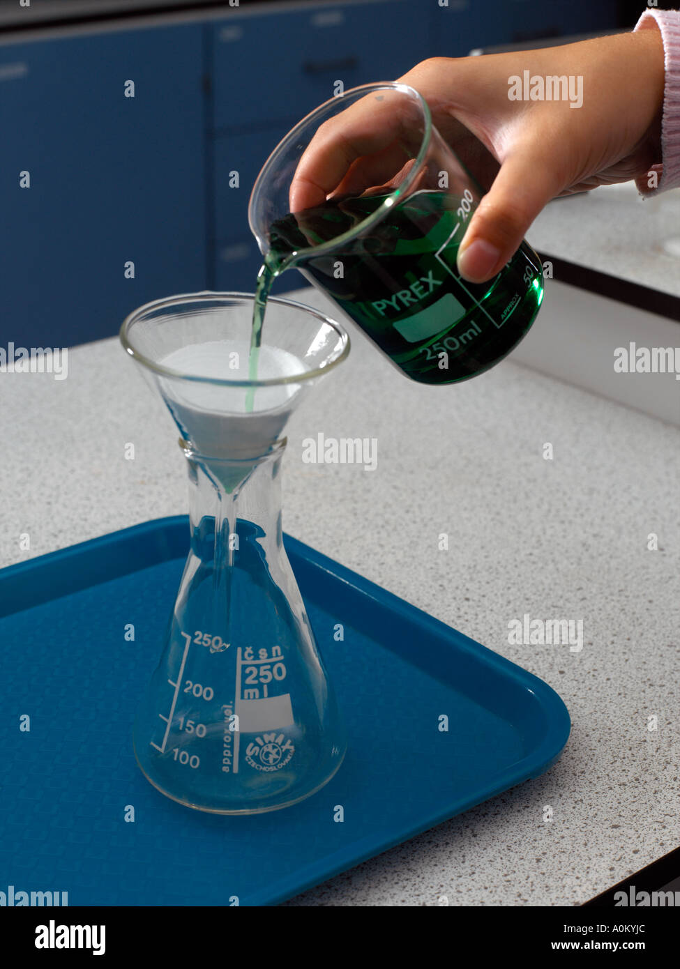 Filter Funnel being used to Filter a Mixture Stock Photo