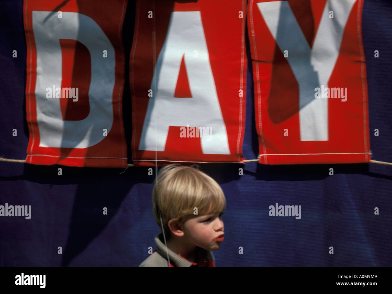 1 one young boy in front of speakers platform Loyalty day parade small town america Stock Photo