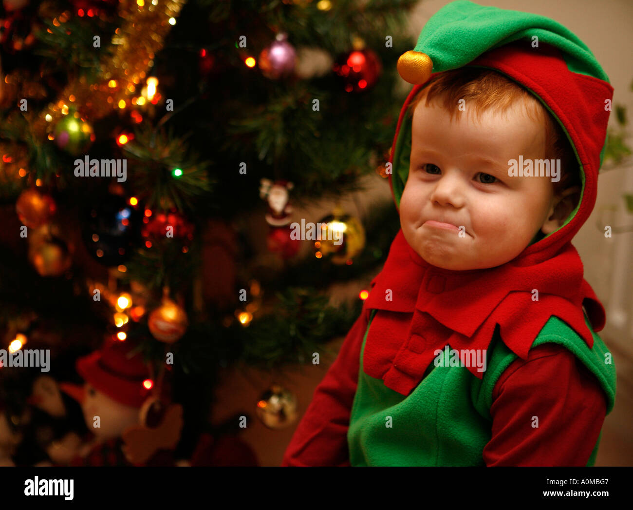Unhappy Child dressed as Elf at Christmas time Stock Photo